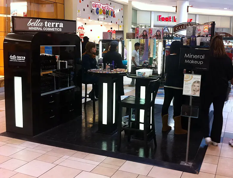 BELLATERRA mineral cosmetics kiosk in a shopping mall with shoppers